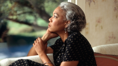 Elderly woman looking out the window