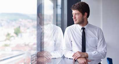 Office worker looking out of a window