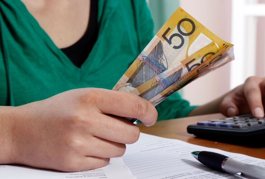 Finances: person counting money with calculator